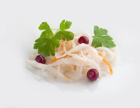 Isoalted handful of sauerkraut with red cranberry and fresh green parsley