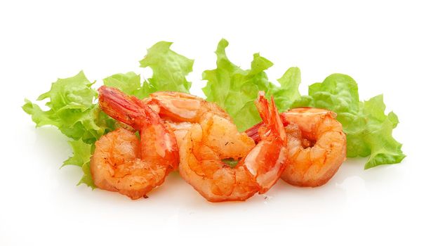 Isolated fried shrimps with fresh green lettuce on the white