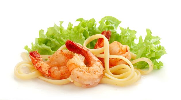 Fried shrimps with pasta and fresh green lettuce