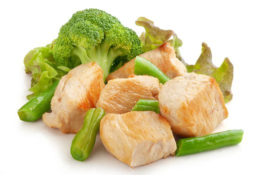 Fried chicken pieces with broccoli, green beans and lettuce on the white