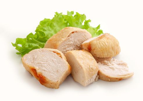Baked chicken breast pieces with fresh green lettuce