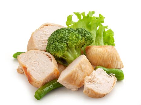 Baked chicken pieces with broccoli, green beans and lettuce on the white