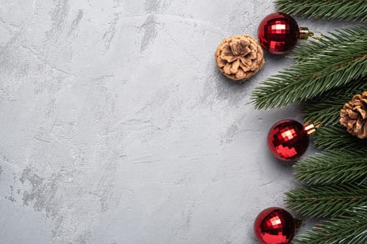 Christmas holidays composition. Red ornament and bauble decorations, fir-tree and pine cones. Copy space