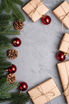 Christmas holidays composition. Red ornament and bauble decorations, fir-tree, gifts and pine cones. Copy space