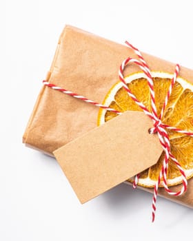 Christmas holidays zero waste paper gift wrapping with dried fruit and tag