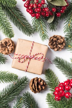Christmas holidays zero waste paper giftbox wrapping with tag, pine cones and fir branches