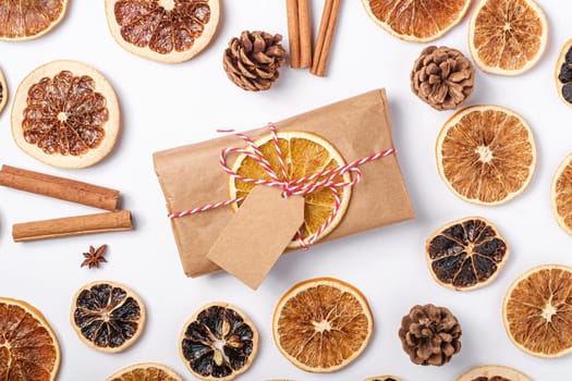 Christmas holidays zero waste paper gift wrapping with dried fruit slices, cinnamon and anise