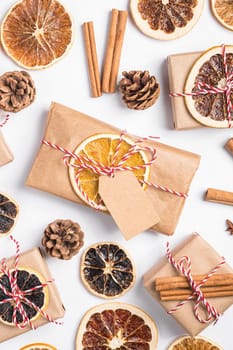 Christmas holidays zero waste paper gift and box wrapping with dried fruit slices, cinnamon and anise