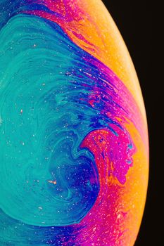 Fluid art made of colorful soap bubble film. Trendy Inkscape blurred background. Alien space planets art. Selective focus.