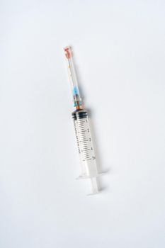 Dirty used plastic syringe, isolated