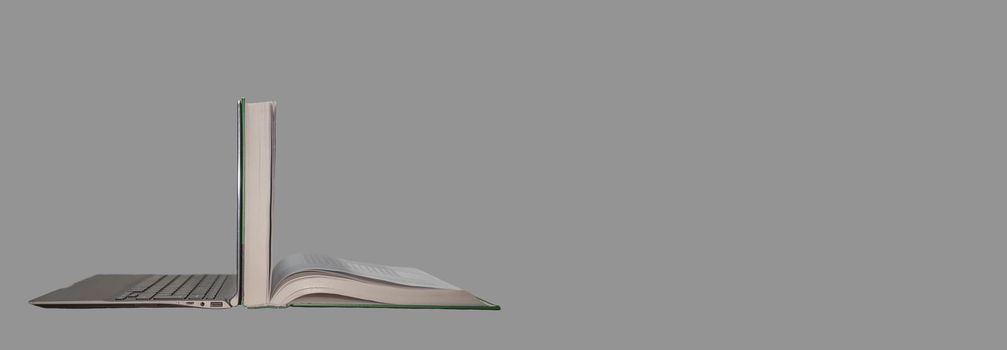 Banner with modern laptop computer positioned back to back with a thick open book. Concept for digital era education, distant learning, and schooling. Grey background with copy space
