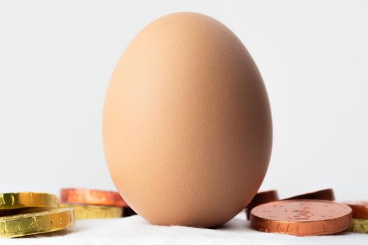 Easter egg standing on a cotton ball and on white background