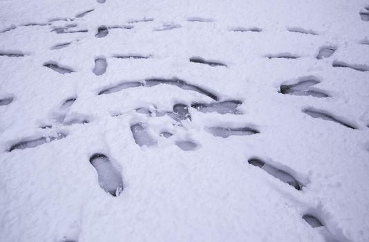 Detail of person's footsteps on a cold and winter day