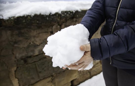 Detail of young woman playing with snow, winter and cold