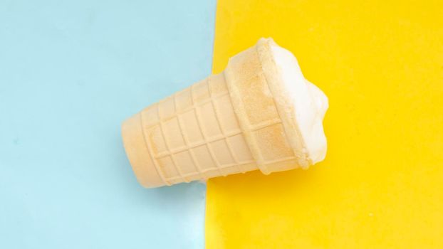 Waffle cup of cream ice cream on pastel blue yellow background.Traditional russian ice-cream