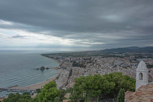 Seascape. Beach and promenade of the resort town of Blanes (Spain). Stock photo.