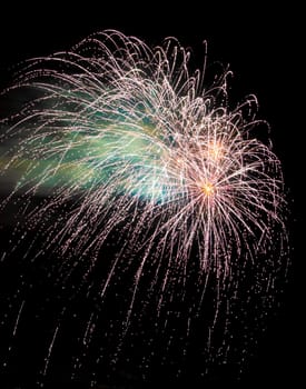 Colorful fireworks isolated on black sky background.