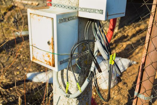 Junction box for connecting electrical wires. Attached to the lamppost. Close-up