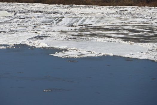The Volga River. Spring ice on the river, water and ice. High quality photo