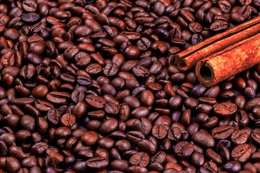 Cinnamon on the coffee beans. A lot of coffee beans background.