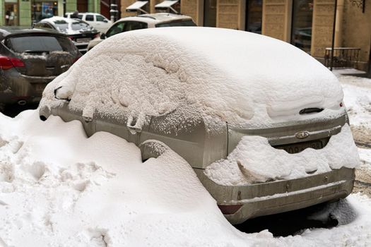 Snow on cars after snowfall. Winter urban scene. Close up