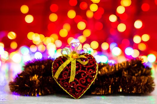 Decorations and ornaments in a colorful Christmas composition isolated on background of blurred lights.