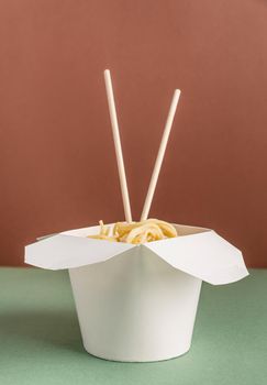 Zero waste and ecology concept. Opened WOK paper box with noodles and chopsticks for mock up design