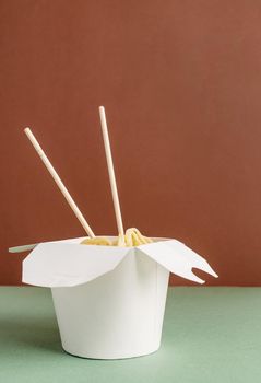 Zero waste and ecology concept. Opened WOK paper box with noodles and chopsticks for mock up design