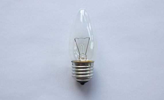 Small tungsten light bulb isolated on white background.