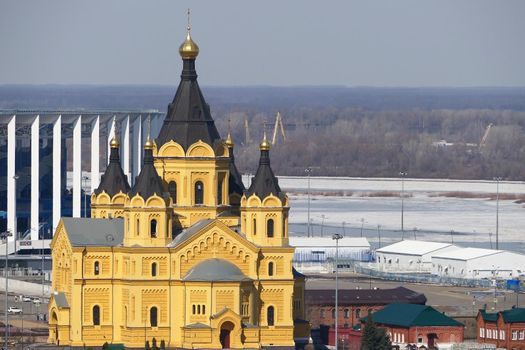  Beautiful Orthodox church made of yellow brick on the river bank. Alexander Nevsky Cathedral on in Nizhny Novgorod, Russia. High quality photo