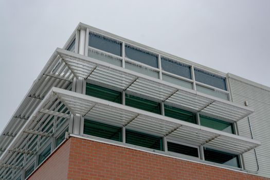 Icicles of freezing rain over window weather shelds of an office building in British Columbia, Canada