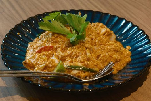 stir fried yellow curry crab on wood dinner table