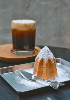 closeup doropan bread with sugar icing and black coffee background