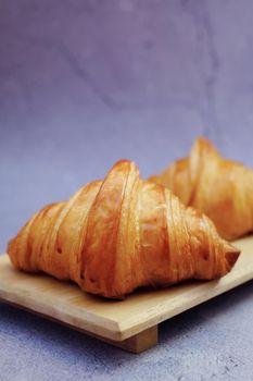 Closeup butter classic croissant on wood plate