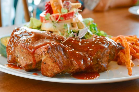 pork ribs grilled with barbecue sauce and sweet potato