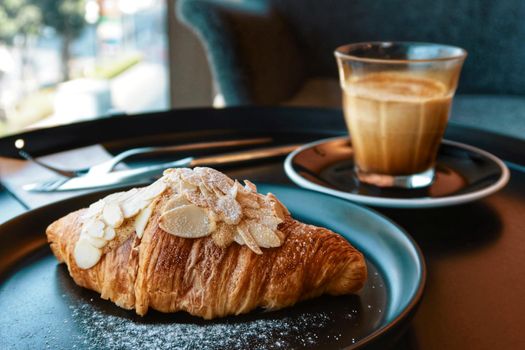 almond croissant butter with dirty coffee background
