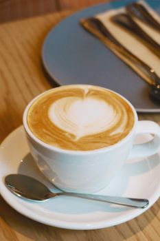 hot flat white coffee on wood table