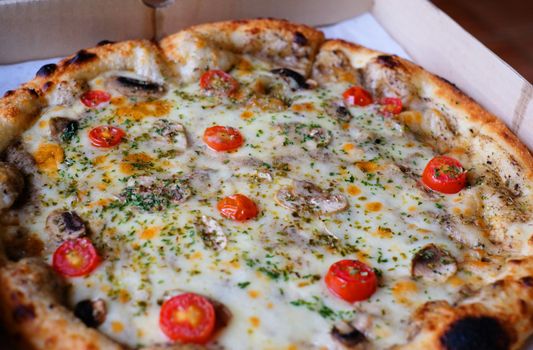 closeup truffle mushroom pizza in the box