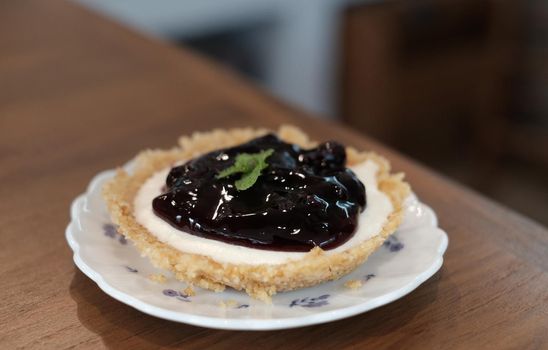 closeup blueberry cheese pie on wood table