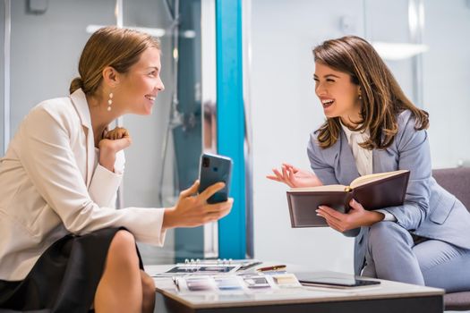 Businesswoman owning small business bath store. She is talking with a customer who is choosing the goods.