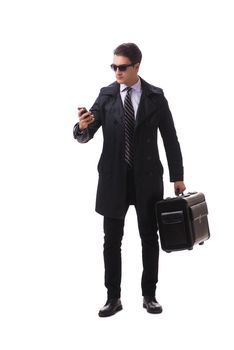 Young businessman with suitcase ready for business trip on white