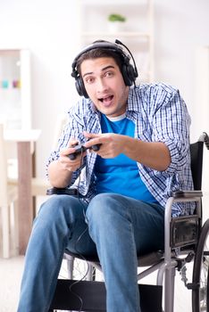 Disabled man playing computer games during rehabilitation