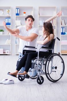 Patient undergoing rehabilitation recovery programme with doctor