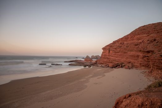 Landscape of Legzira Beach with its natural arches at the coast of Atlantic ocean. Legzira Beach is located on the ocean coast of Morocco, in Sidi Ifni, close to Agadir.