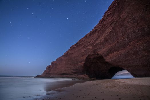 Landscape of Legzira Beach with its natural arches at the coast of Atlantic ocean. Legzira Beach is located on the ocean coast of Morocco, in Sidi Ifni, close to Agadir.