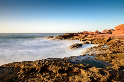 Landscape of Legzira Beach with its natural arches at the coast of Atlantic ocean. Legzira Beach is located on the ocean coast of Morocco, in Sidi Ifni, close to Agadir.