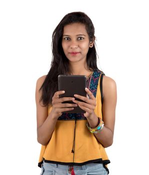 Portrait of a happy young girl using mobile phone isolated over white background