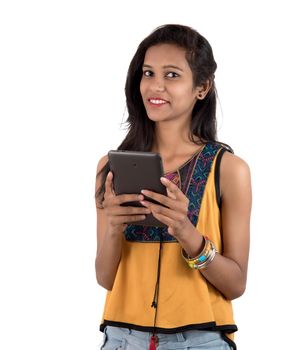 Portrait of a happy young girl using mobile phone isolated over white background