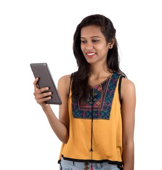 Portrait of a happy young girl using mobile phone isolated over white background