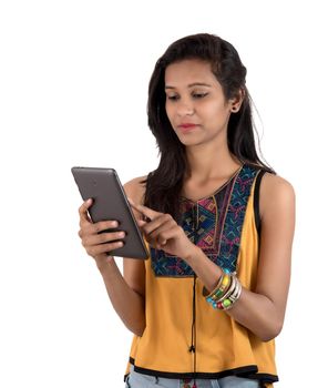 Portrait of a happy young girl using mobile phone isolated over white background